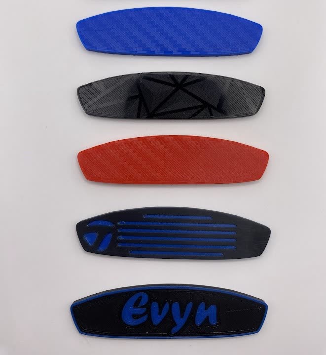A range of 3D printed putter face inserts in different colours and patterns