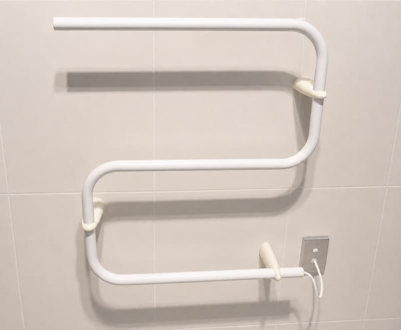 A heated towel rail mounted on a tiled bathroom wall on 3D printed brackets